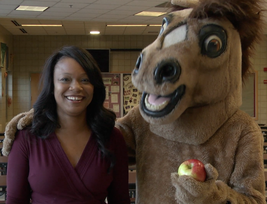Principal Mest with school mascot Marty the Mustang in the cafeteria.