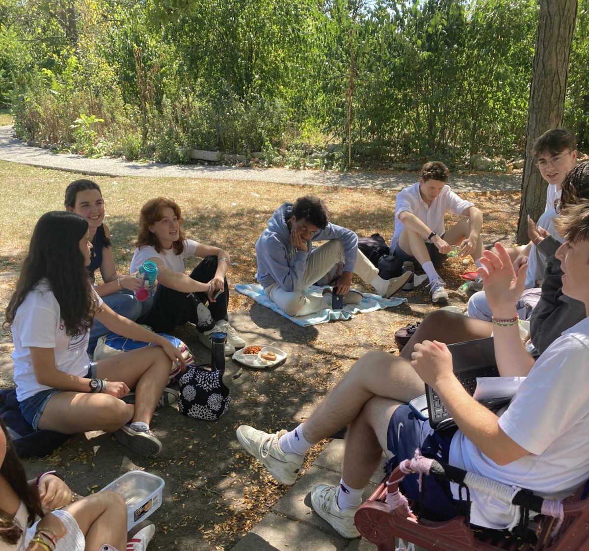 A group of juniors and seniors enjoy their lunch outside