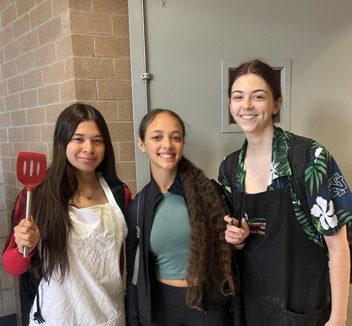 Juniors Evy Chan, Bridget Ward, and Sam Wiviott dressed on Barbecue Dad vs Soccer Mom day