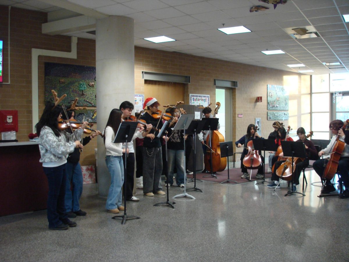 Orchestra students performing in the hallway before class.